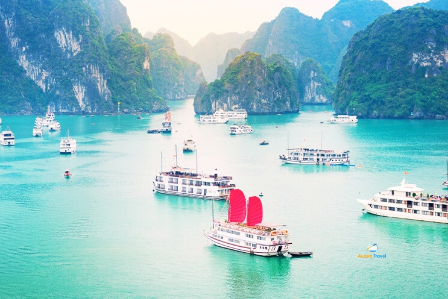 Halong Bay cruise ships sailing among limestone islands Vietnam – Auasia Travel